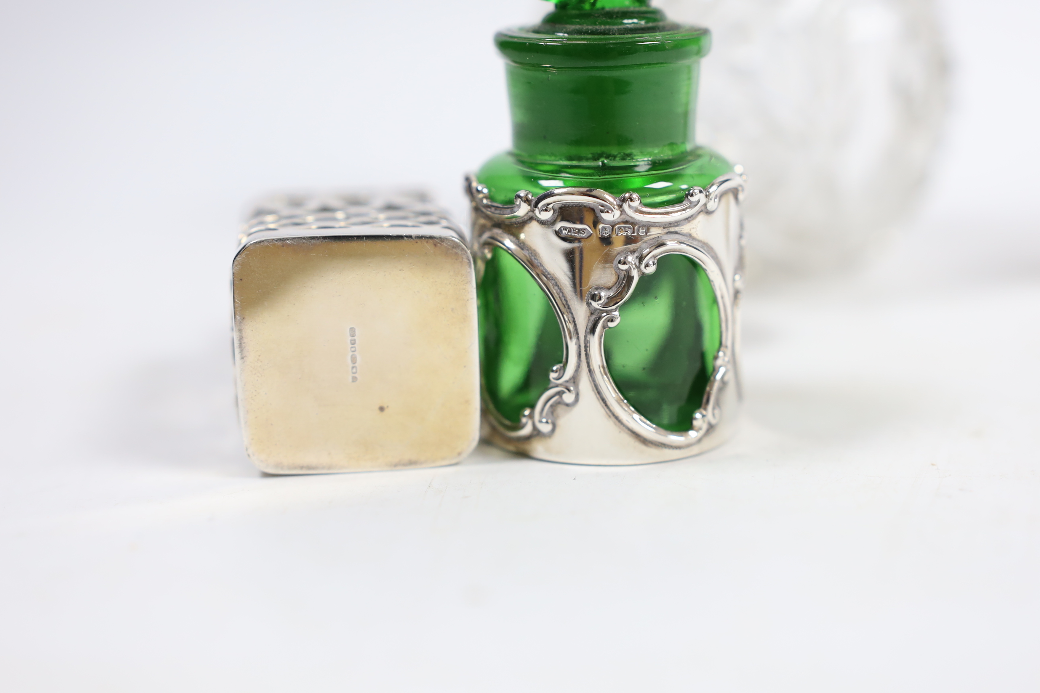 A George V silver mounted cut glass globular scent bottle, London, 1918, lacking stopper?, 11.2cm and three other silver mounted toilet jars.